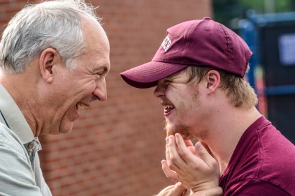 Man &amp; boy in baseball cap by Nathan Anderson